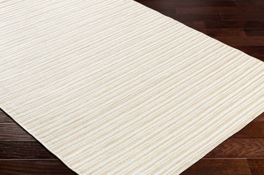 Close-up of Greg Beige Area Rug showing a striped pattern and woven texture on dark wood flooring. Corner