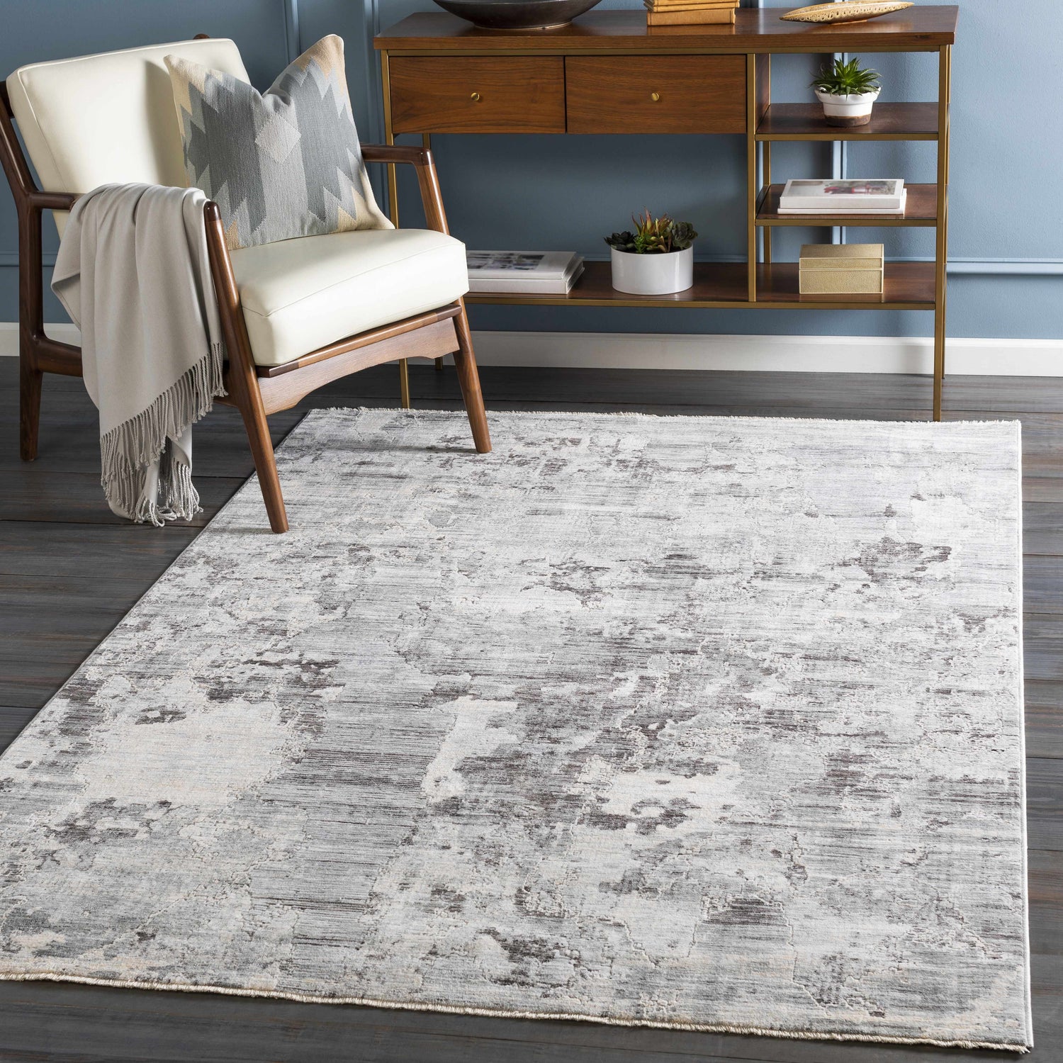 Entryway scene with Johnetta Carved Statement Rug in gray, ivory, and charcoal. Modern console table and chair. Roomscene-Rectangle