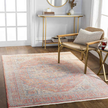 Entryway with Tusa Red Area Rug, gold console table, and woven chair on a dark wood floor. Roomscene-Rectangle