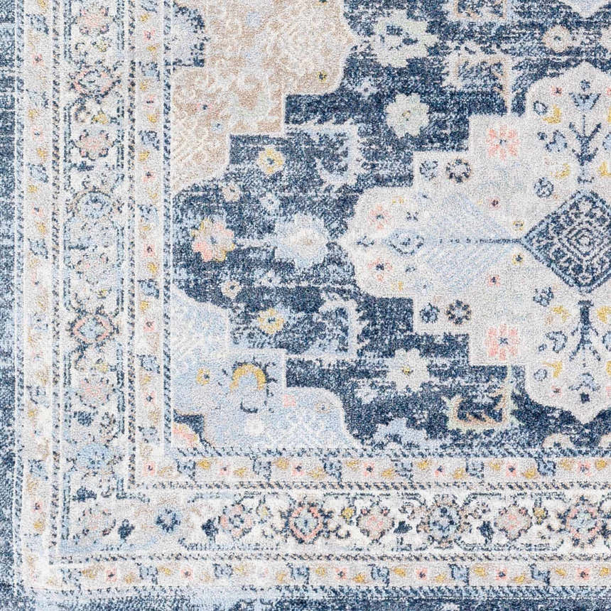 Close-up of Jara Washable Area Rug showing traditional patterns in dark gray, denim blue, and light gray. Soft, textured design. Swatch