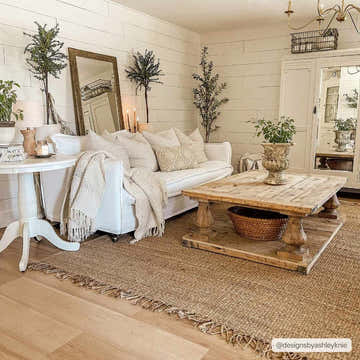 Farmhouse living room with a white sofa and a natural Oaks Perfect Flatweave Jute Rug with fringe. Roomscene-Rectangle