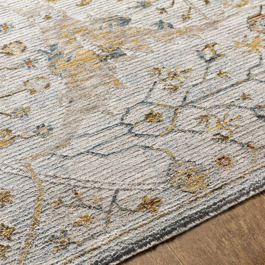 Close-up of the Kabungahan Oushak Style Floral Rug. Features brick red, cream, denim, and mustard floral pattern. Texture