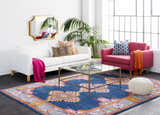 Living room scene with white sofa, pink chair, and Kaitlyn Navy Area Rug. Bohemian style. Roomscene-Rectangle