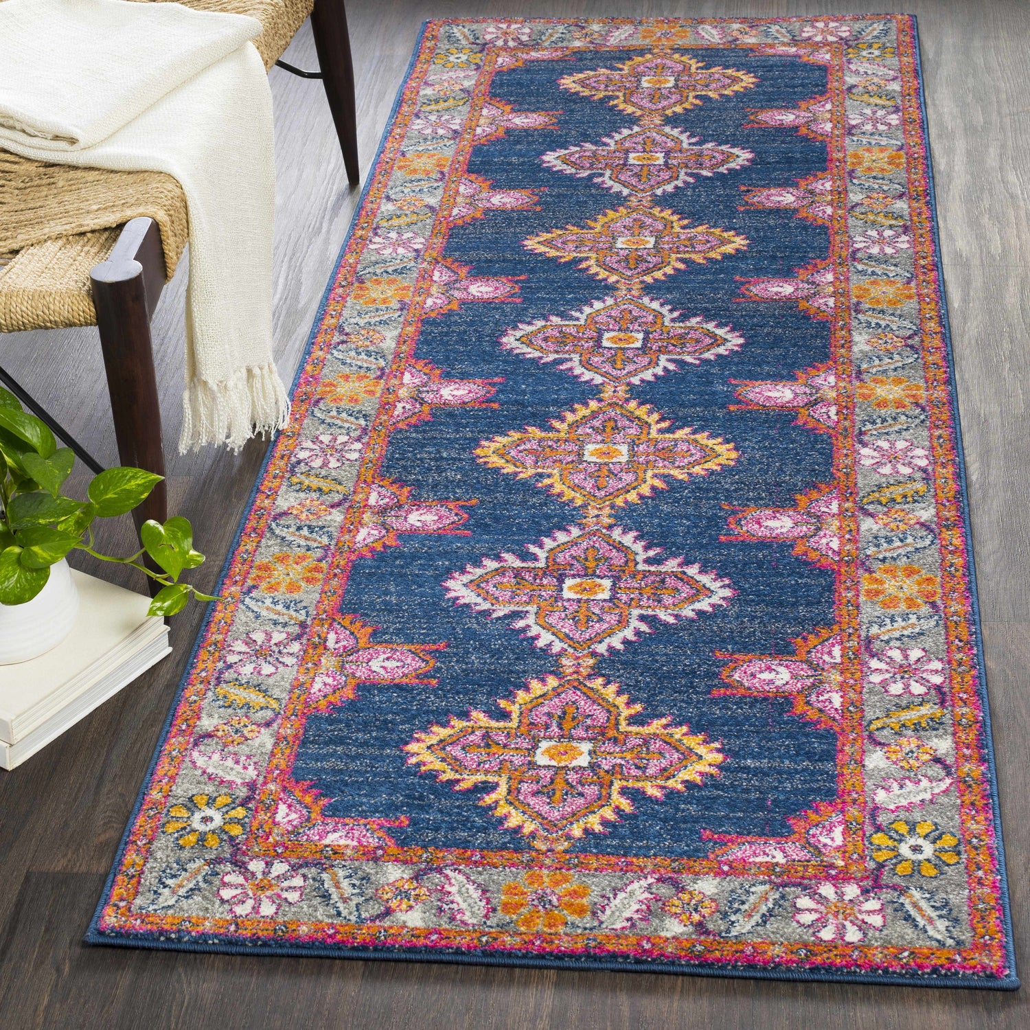 Bohemian style runner rug. The Kaitlyn Navy Area Rug features a navy, pink, and orange traditional design. Roomscene-Runner