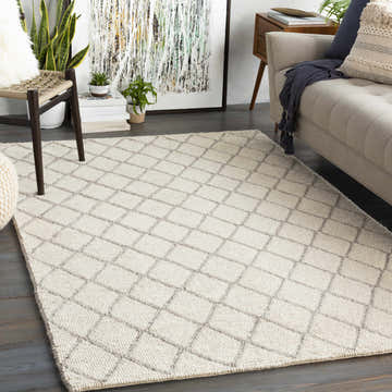 Living room scene with a cream sofa and the Kanopolis Carpet in a gray diamond pattern. Roomscene-Rectangle