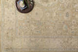 Close-up of the Karalee Handmade Wool Area Rug featuring beige, brown, and light blue traditional patterns. Styleshot
