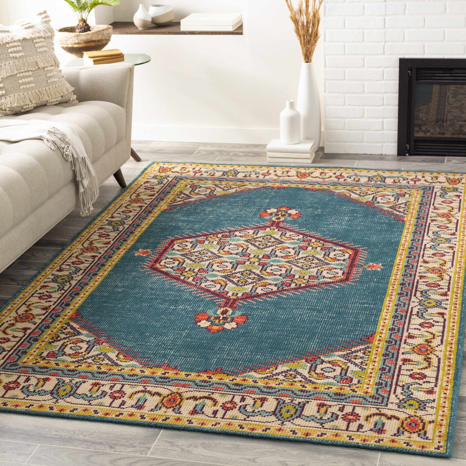 Living room scene with a teal Kaser Carpet. Farmhouse style with beige sofa and white brick fireplace. Roomscene-Rectangle