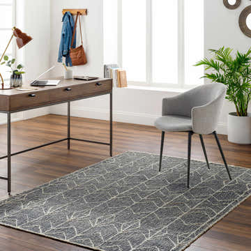 Home office with a gray chair and the Kate Area Rug, a dark gray rug with a geometric pattern. Roomscene-Rectangle