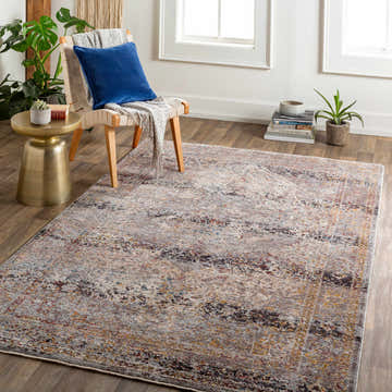 Living room scene with a Kaynakkaya Area Rug in beige, black, and orange. Chair with blue pillow and gold side table. Roomscene-Rectangle