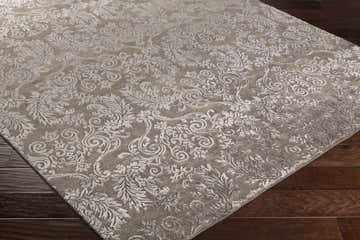 Close-up of the charcoal Keiser Area Rug showing its floral, hand-knotted design and wool viscose blend texture. Corner