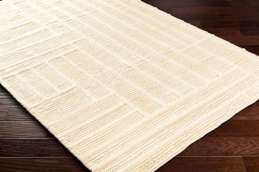 Close-up of the hand woven Kelburn Area Rug. Light slate wool rug with a contemporary, textured stripe pattern. Corner