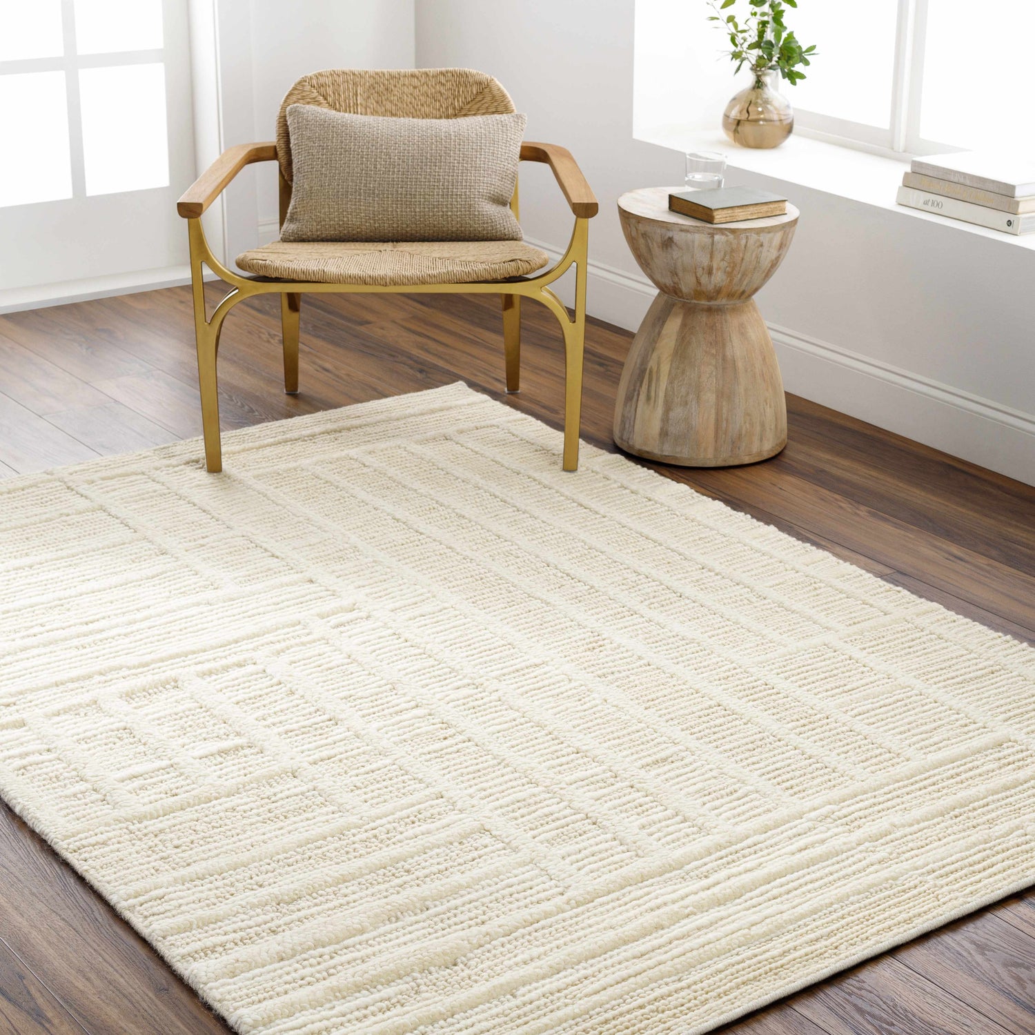 Living room scene with a light slate Kelburn Area Rug, woven chair, and wood side table. Roomscene-Rectangle