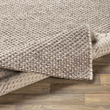 Close-up of the hand woven Keldron Clearance Rug. Charcoal and cream wool and viscose blend with a textured, contemporary design. Fold
