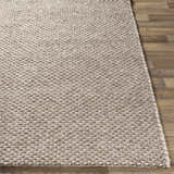Close-up of the hand woven Keldron Clearance Rug. Charcoal, cream, and dark brown tones. Contemporary style. Viscose and wool blend. Front