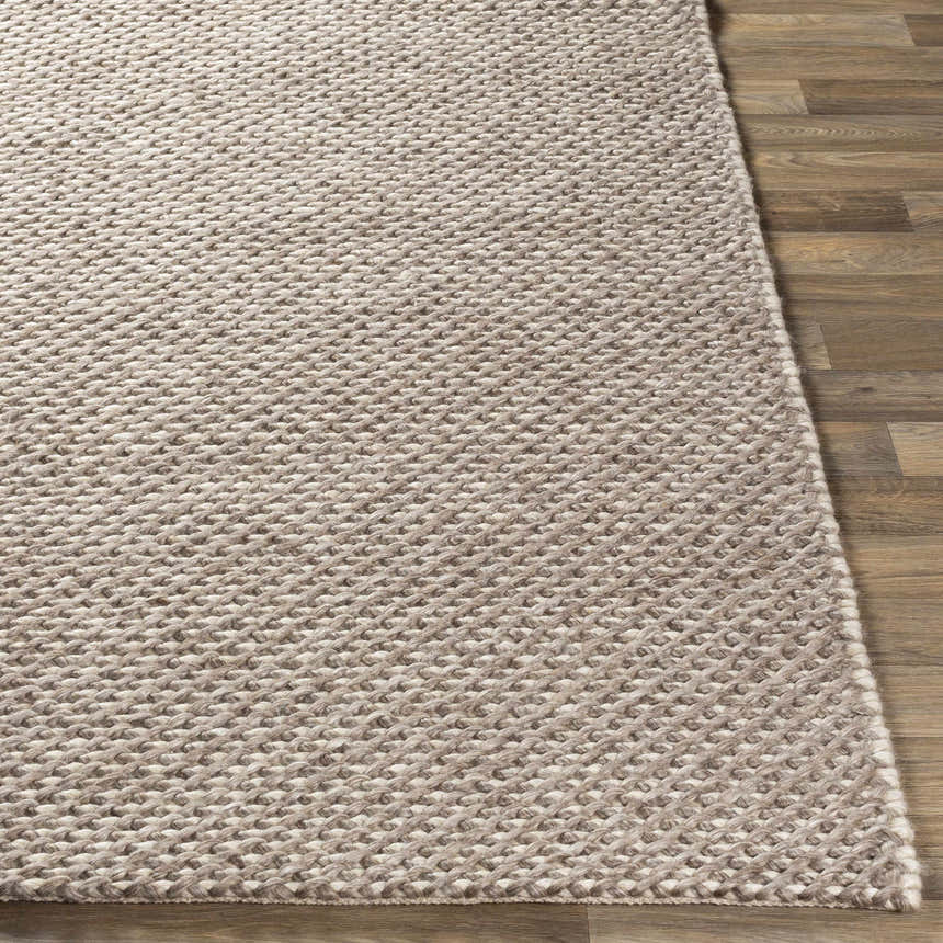 Close-up of the hand woven Keldron Clearance Rug. Charcoal, cream, and dark brown tones. Contemporary style. Viscose and wool blend. Front