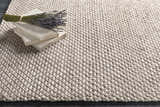 Close-up of the hand woven Keldron Clearance Rug. Charcoal and cream wool blend with a textured, contemporary design. Styleshot