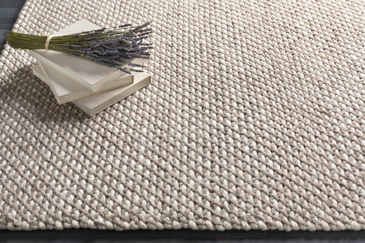 Close-up of the hand woven Keldron Clearance Rug. Charcoal and cream wool blend with a textured, contemporary design. Styleshot