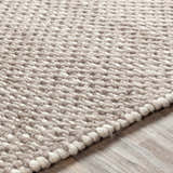 Close-up of the hand-woven Keldron Clearance Rug. Charcoal, cream, and dark brown wool and viscose texture. Texture