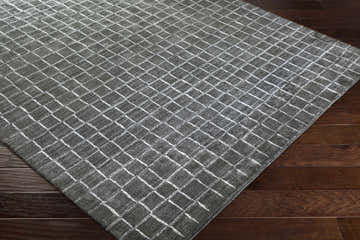 Close-up of the charcoal and white Kenesaw Clearance Rug showing its hand-knotted texture and contemporary grid pattern. Corner