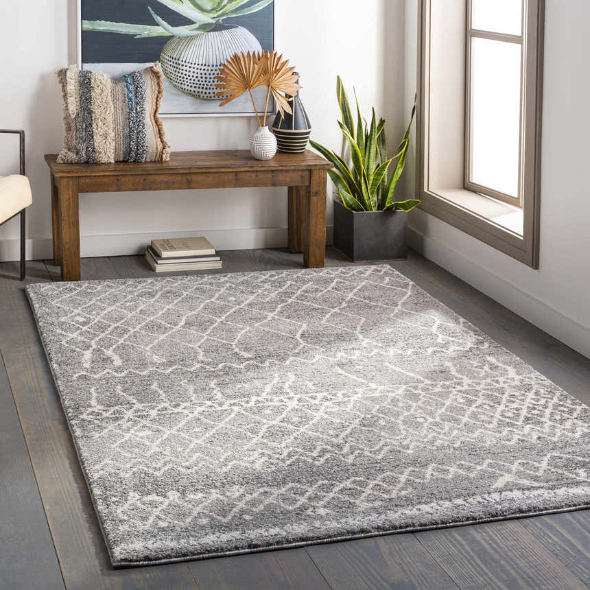 Entryway with a gray Kessingland Area Rug, wood bench, and decorative accents. Roomscene-Rectangle