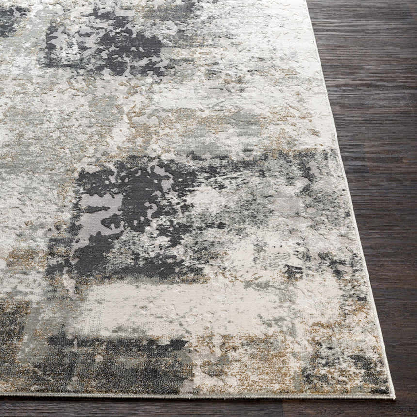Close-up of the contemporary Kiana Area Rug, featuring a distressed abstract pattern in gray, white, and tan on dark wood floor. Front
