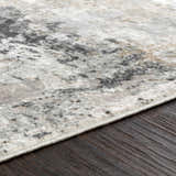 Close-up of the Kiana Area Rug showing its abstract gray, beige, and white pattern and soft, plush texture. Texture