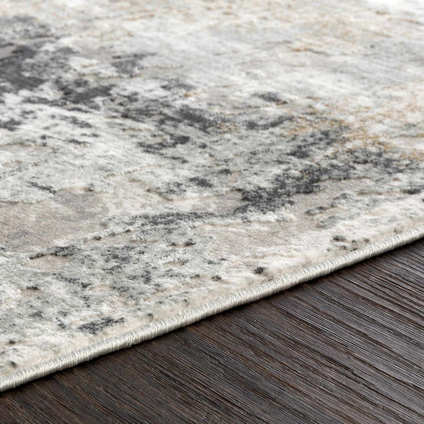 Close-up of the Kiana Area Rug showing its abstract gray, beige, and white pattern and soft, plush texture. Texture