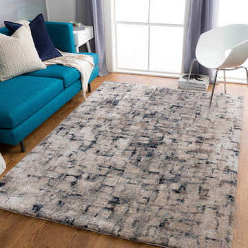 Living room scene with a teal sofa and the Kilbirnie Area Rug in beige, gray, and black. Roomscene-Rectangle
