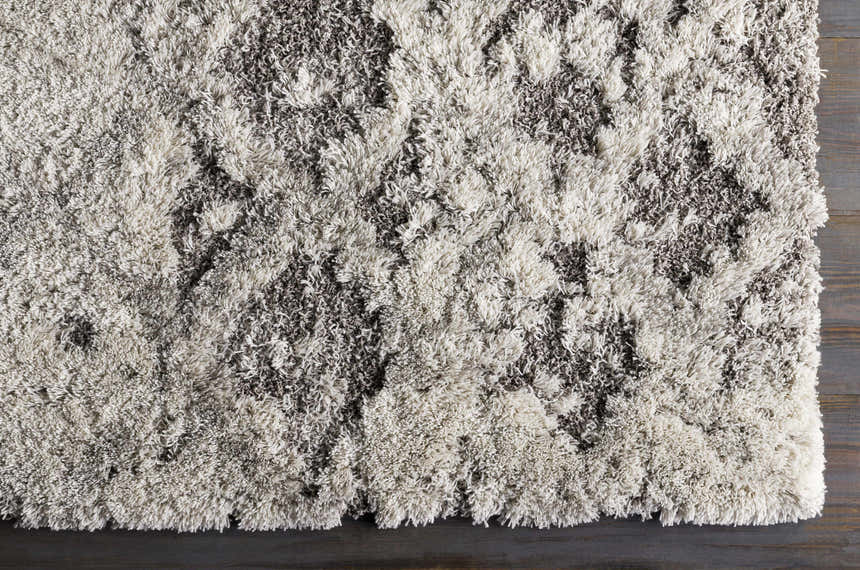 Close-up of the plush Kilgetty Gray Cloudy Shag Rug featuring a soft gray and off-white abstract pattern. Swatch