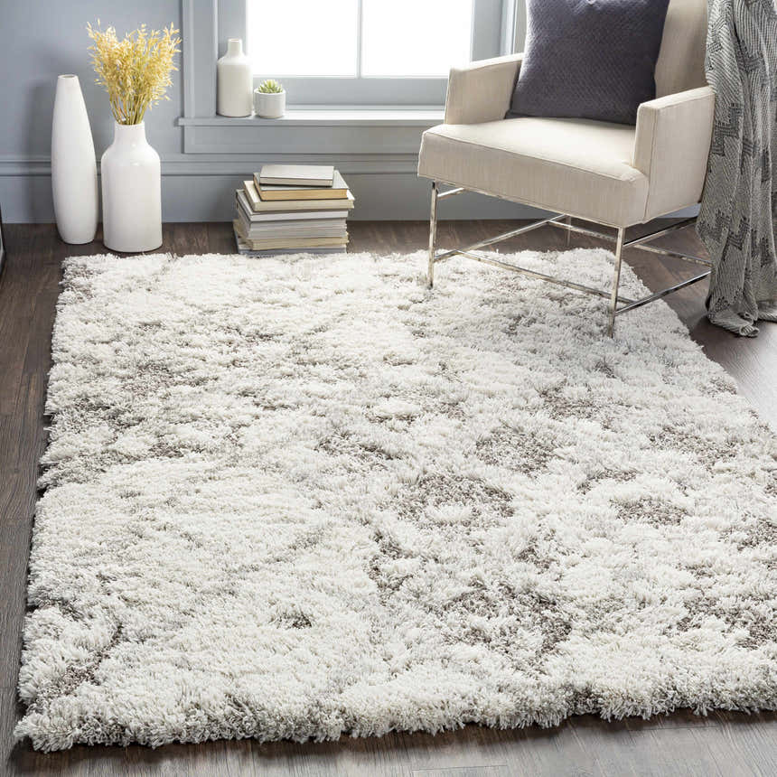 Living room scene with a Kilgetty Gray Cloudy Shag Rug, cream chair, gray pillow, and vases. Roomscene-Rectangle