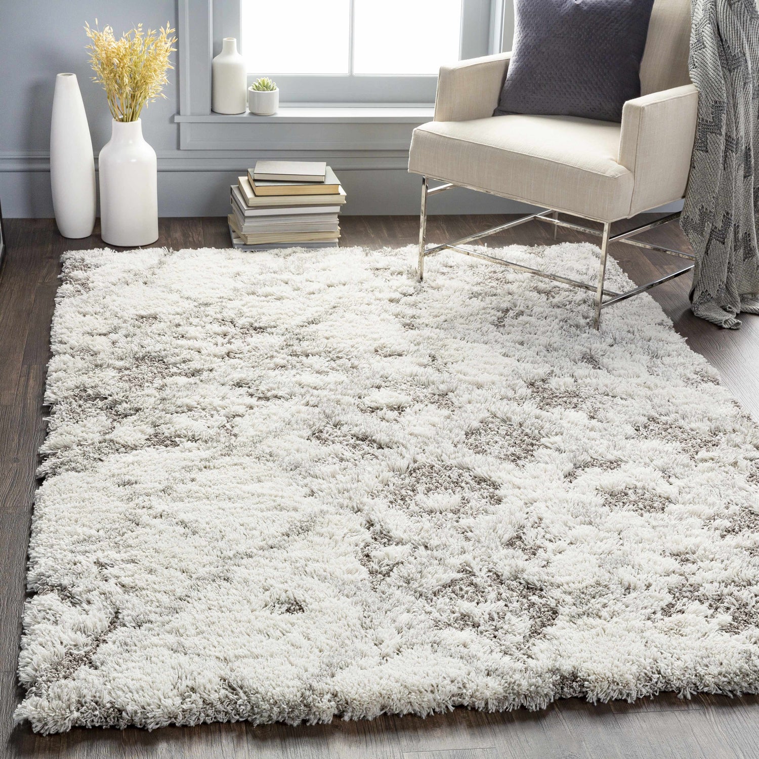 Living room scene with a Kilgetty Gray Cloudy Shag Rug, cream chair, gray pillow, and vases. Roomscene-Rectangle