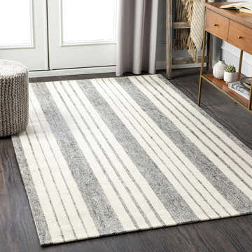 Living room scene with a gray and white striped Kilmore Area Rug, wood floors, and modern decor. Roomscene-Rectangle