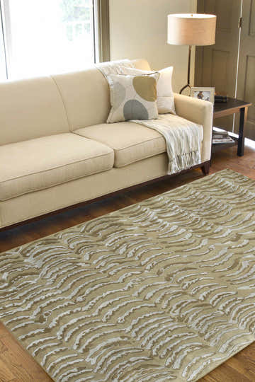 Living room scene with a neutral sofa and Kirksey Premium Area Carpet in Arctic Stone and brown tones. Roomscene-Rectangle