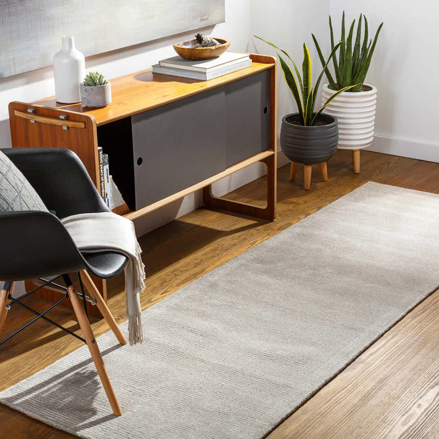 Modern hallway with light gray Keller Area Rug runner, wood floors, and mid-century cabinet. Roomscene-Runner