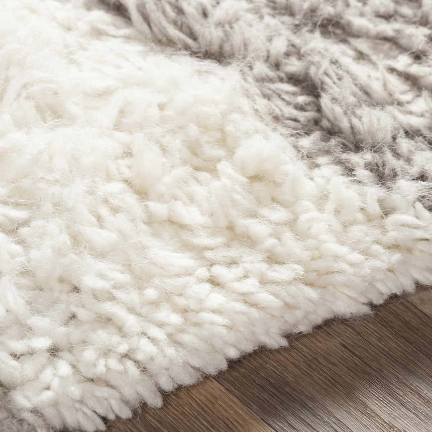 Close up of the hand woven Kingsthorpe Area Rug showing cream and taupe shag texture. Texture