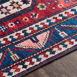 Detailed close-up of the Kodiak Red&Blue Oriental Area Rug. Features traditional patterns in red, blue, pink, and cream. Texture