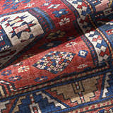 Close-up of the Kodiak Red&Blue Oriental Area Rug, showcasing its traditional pattern, and rich colors like red, blue, and lambswool. Fold