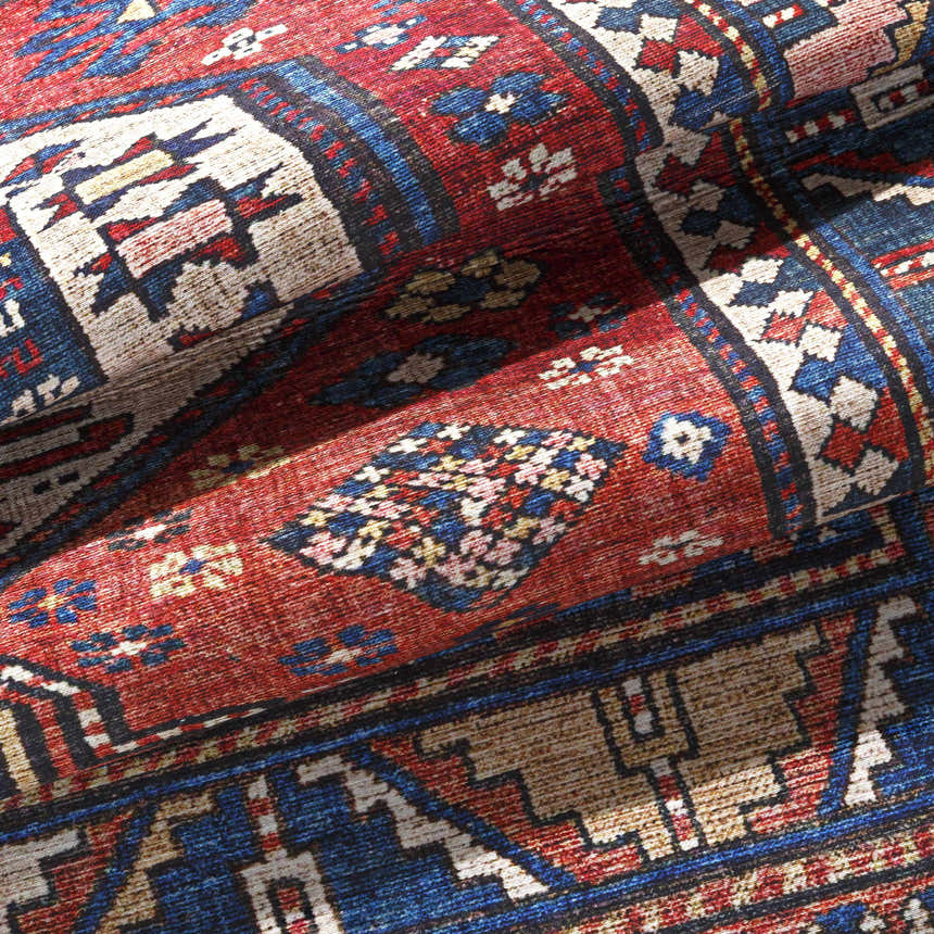 Close-up of the Kodiak Red&Blue Oriental Area Rug, showcasing its traditional pattern, and rich colors like red, blue, and lambswool. Fold