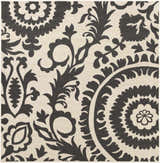 Close-up of Kongiganak Area Rug in black and light beige. Olefin rug features a floral and botanical pattern. Swatch