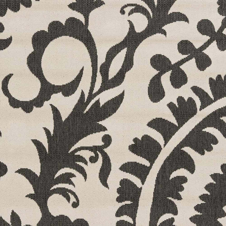 Close-up of the Kongiganak Area Rug, showing a black floral pattern on a light beige, textured background. Swatch