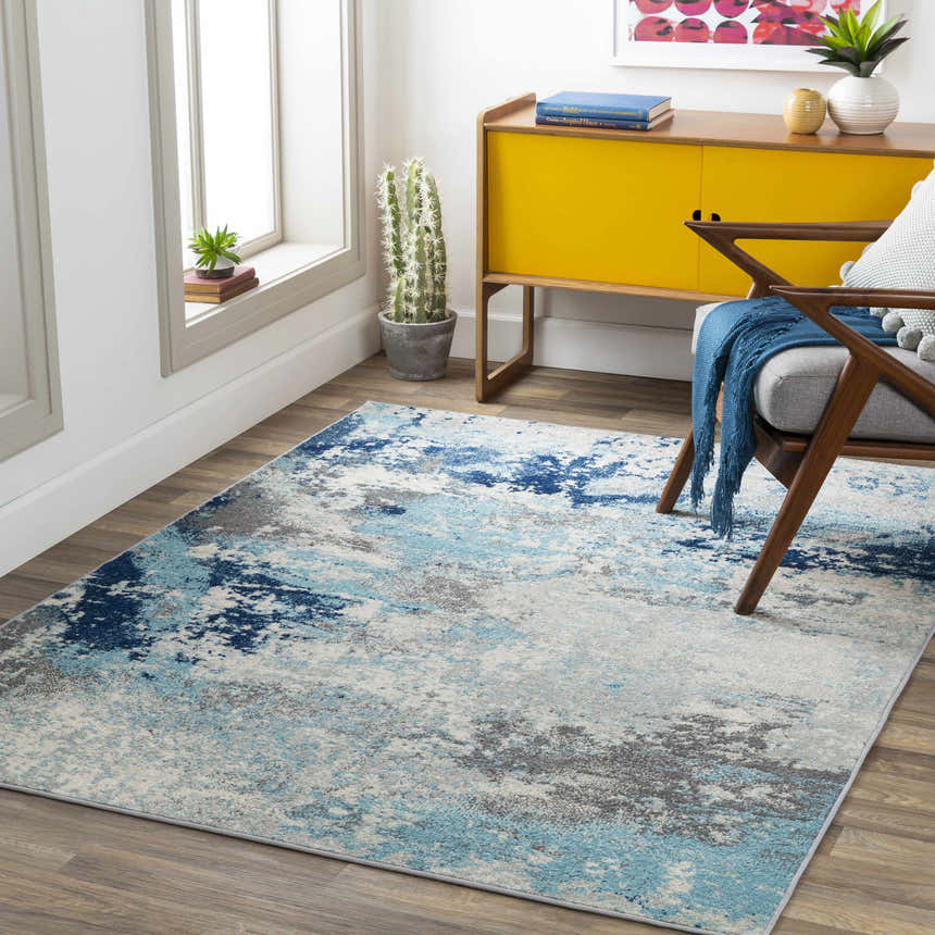 Living room scene with aqua, charcoal, and gray Kuluin Area Rug. Modern design with yellow cabinet and chair. Roomscene-Rectangle