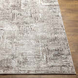 Close up of the Kutloanong Area Rug showing its abstract charcoal, gray, and ivory pattern. Front