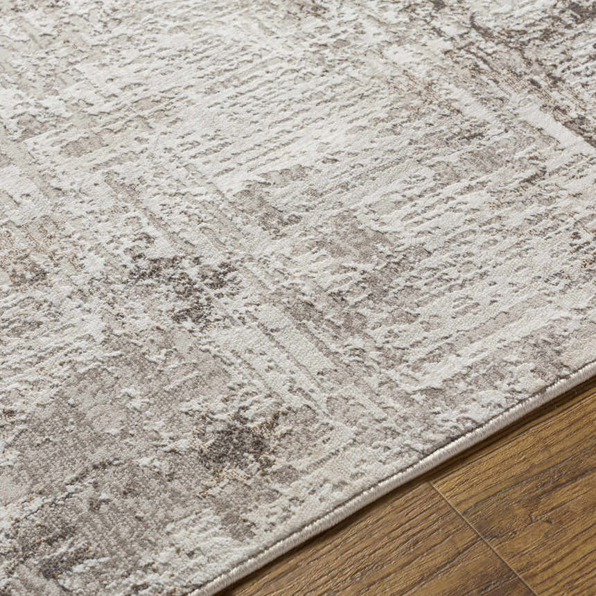 Close-up of the Kutloanong Area Rug showing a contemporary charcoal and ivory pattern and soft, textured polyester material. Texture