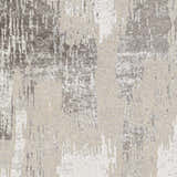 Close-up of Kuyucak Washable Area Rug featuring a contemporary abstract pattern in brown, cream, gray, and light beige tones. Swatch
