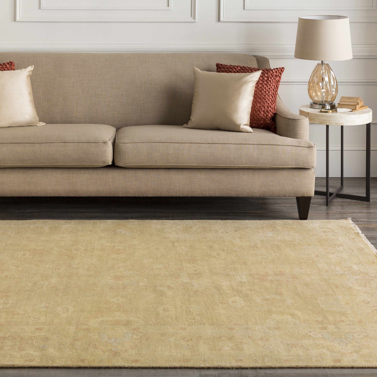 Living room scene with a tan sofa and the Langhorne Carpet in dusty pink and mustard tones. Roomscene-Rectangle
