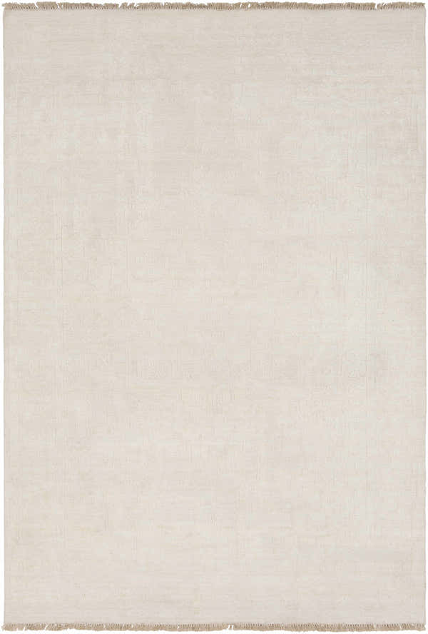 Close-up of the hand-knotted Larimer Area Rug. Cream wool rug with subtle, vintage-inspired pattern and fringe. Design-Rectangle