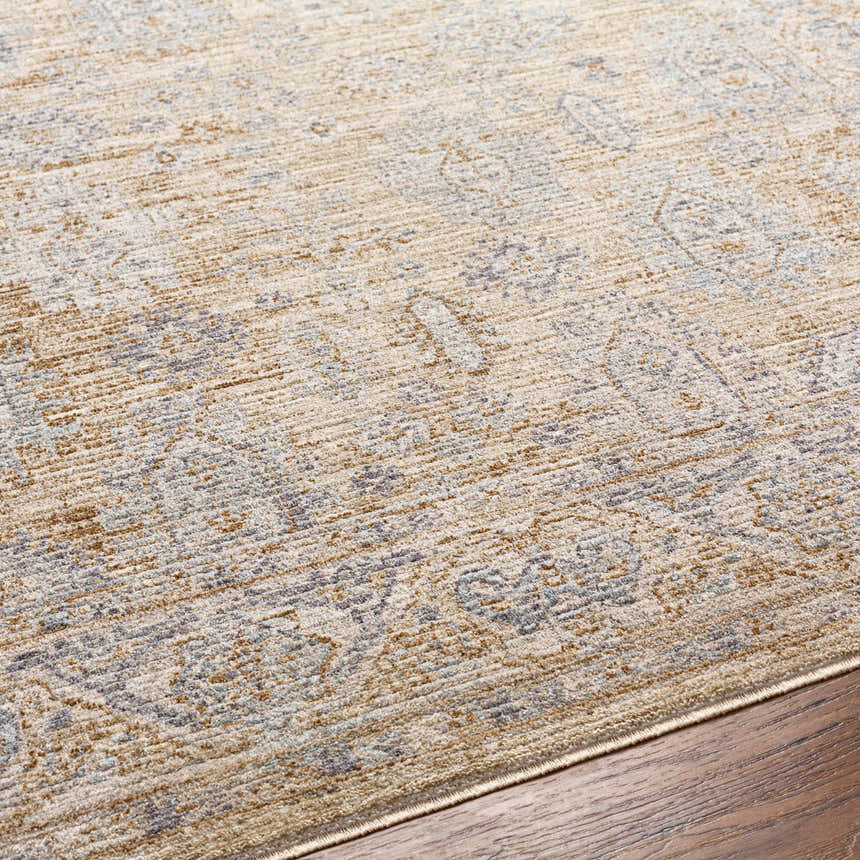 Close-up of the Coby Cream Avant Garde rug. Luxe pile with traditional brown, gray, and teal oriental pattern. Texture