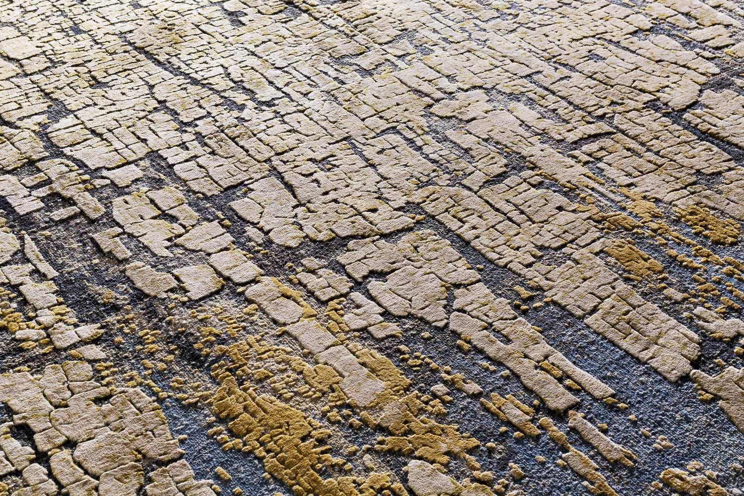 Close-up of the Latour Carpet showing a contemporary design with blue, olive, and taupe tones. Hand-knotted texture. Styleshot
