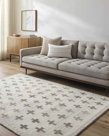 Living room scene with a Lotta Ivory Modern Wool Area Rug, gray sofa, and wood cabinet. Roomscene-Rectangle
