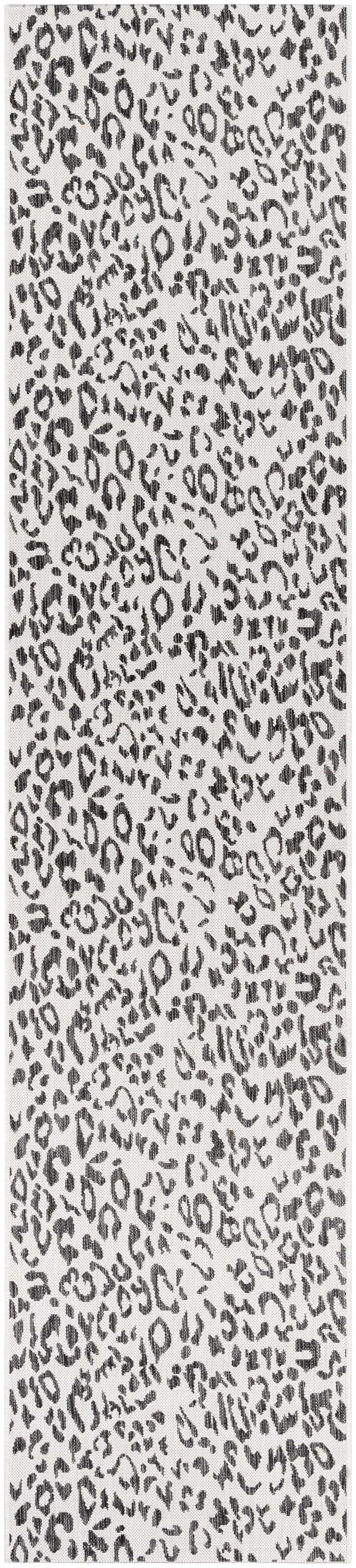 Close-up of Alderbury White Leopard Print Rug. Black and charcoal animal spots on an off-white, machine woven polypropylene rug. Design-Runner-2712